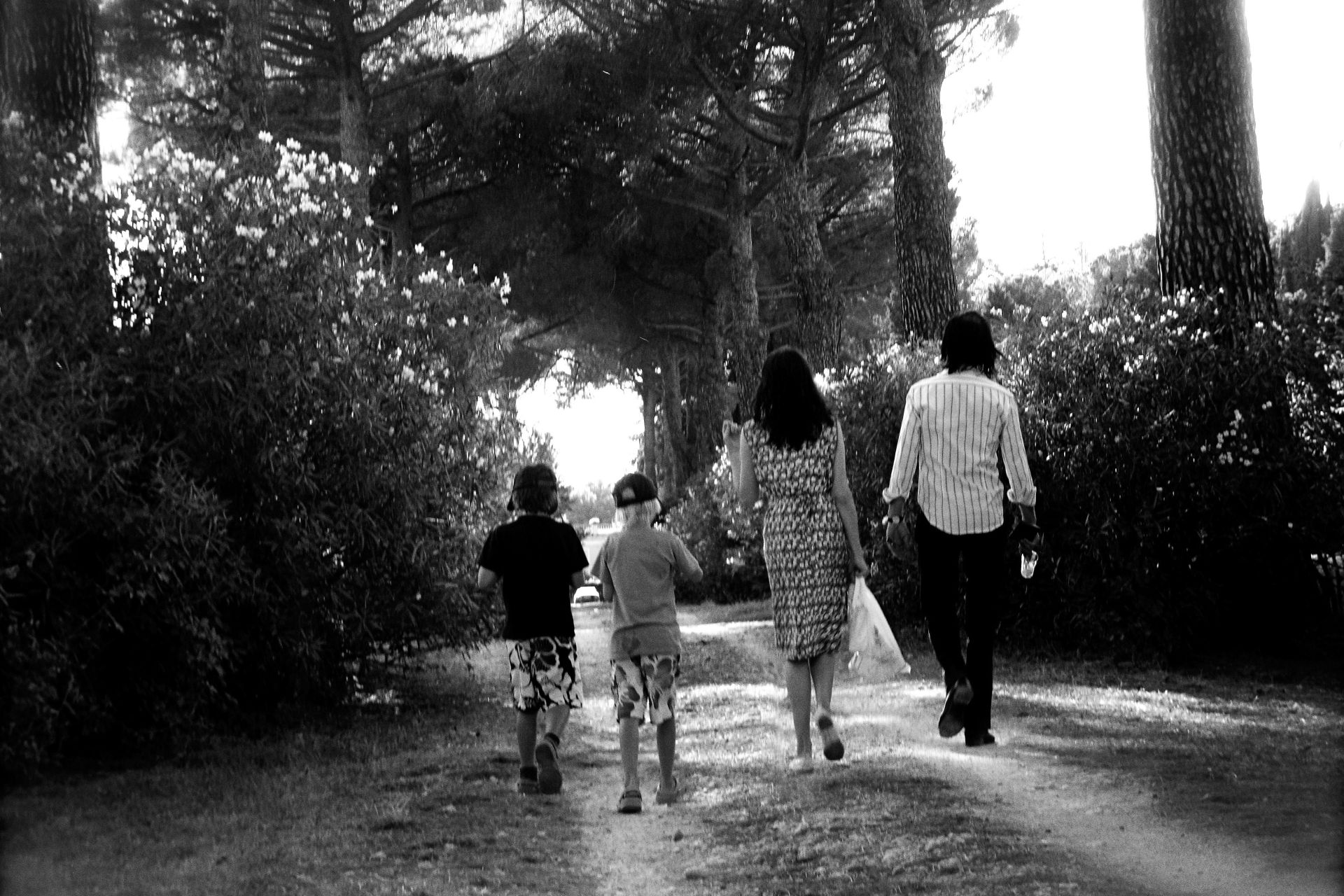 Rear of Susie and Nick walking with their children
