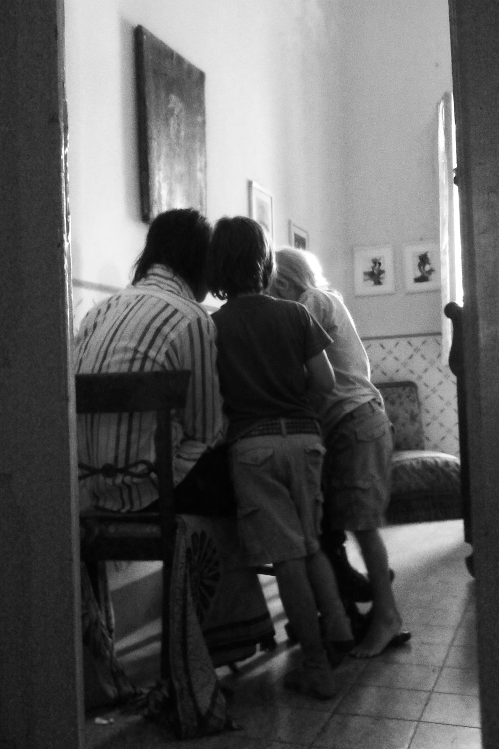Susie and Nick huddling at their table with their young child