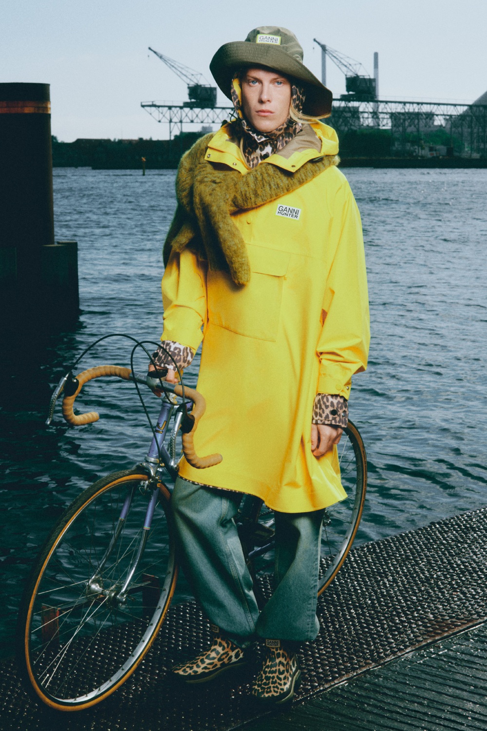 Model wearing oversized poncho from GANNI x Hunter collection