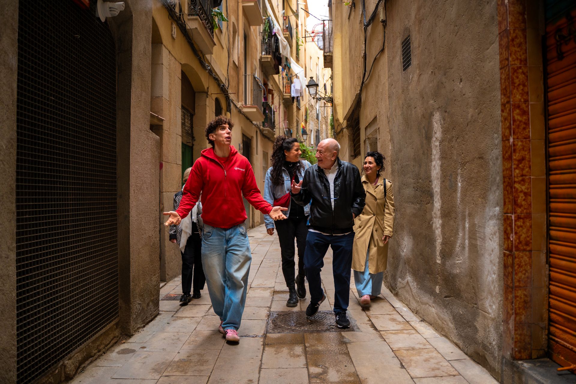 Juan leading a tour group down a narrow street in Barcelona