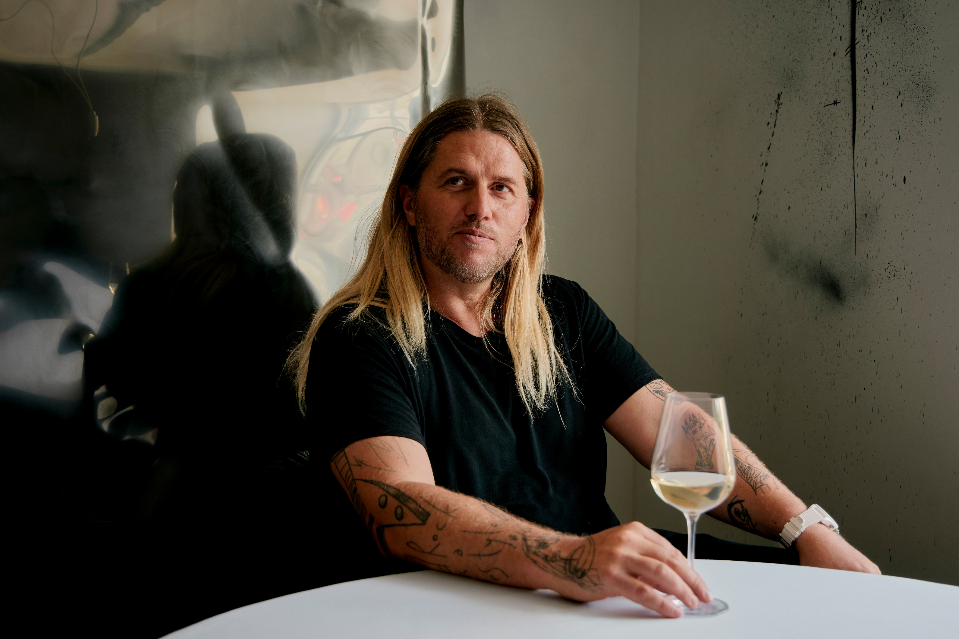 Michael O'Hare with a glass of wine in Café Eighty-One