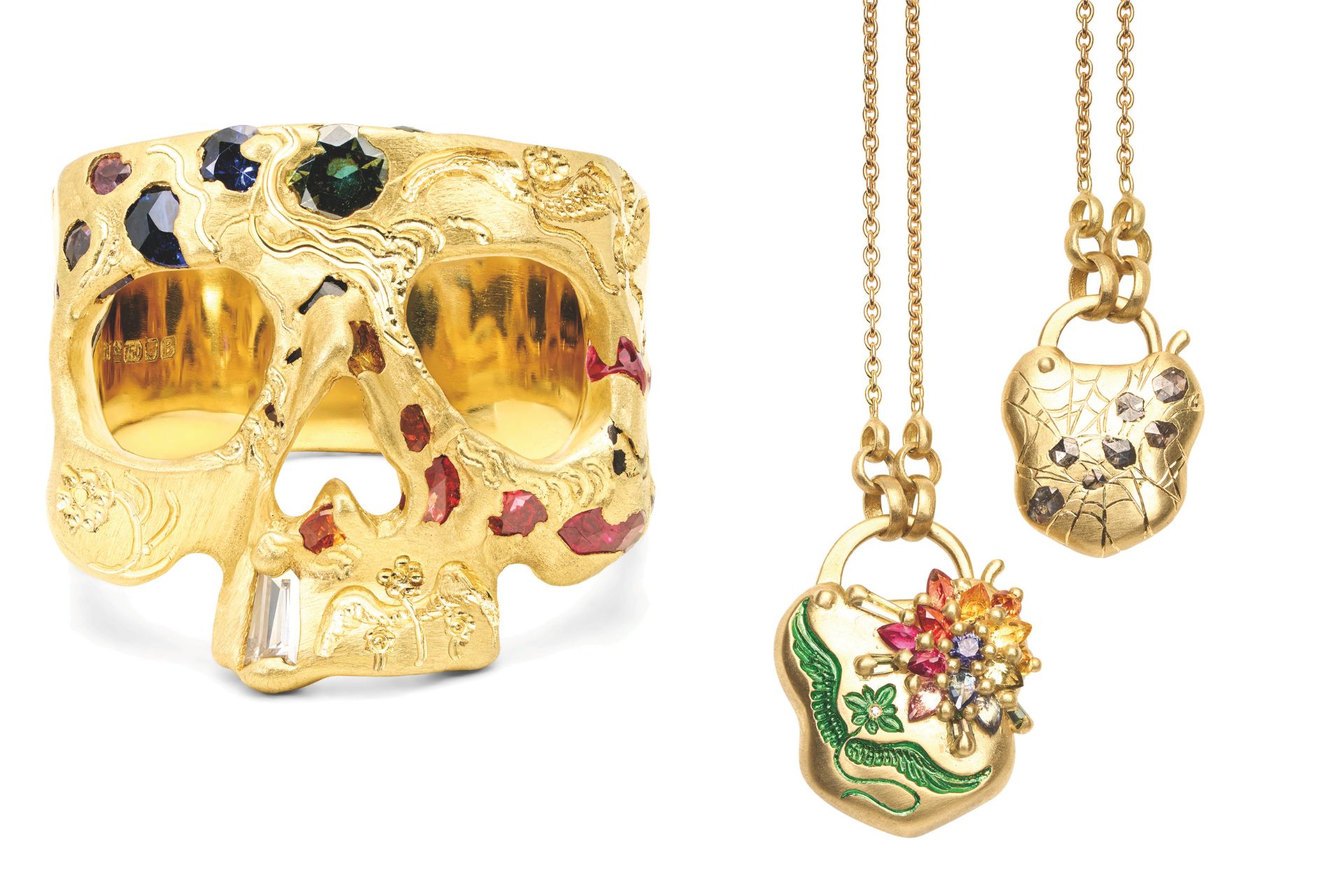 Gold jewel-encrusted skull ring and two gold jewel-encrusted necklaces